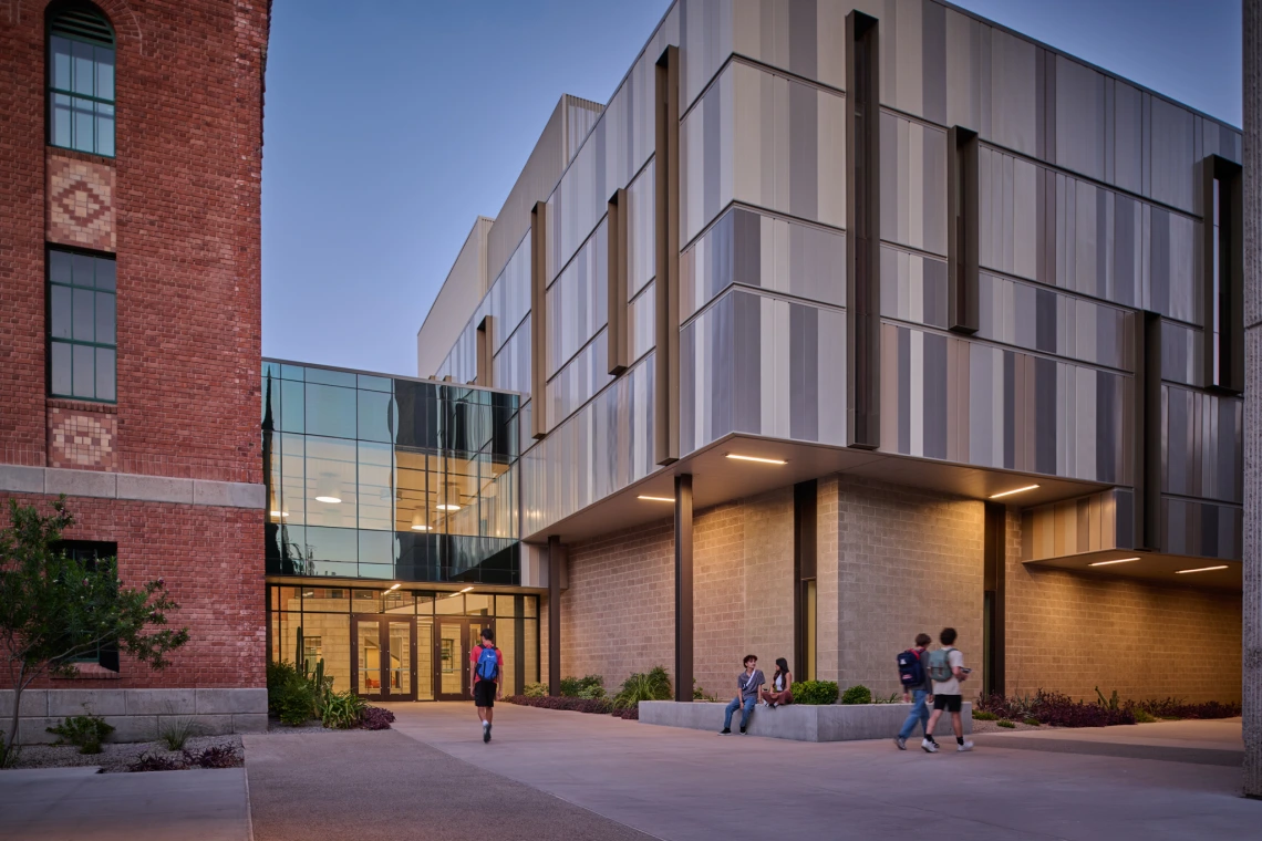 student walking by Commons building